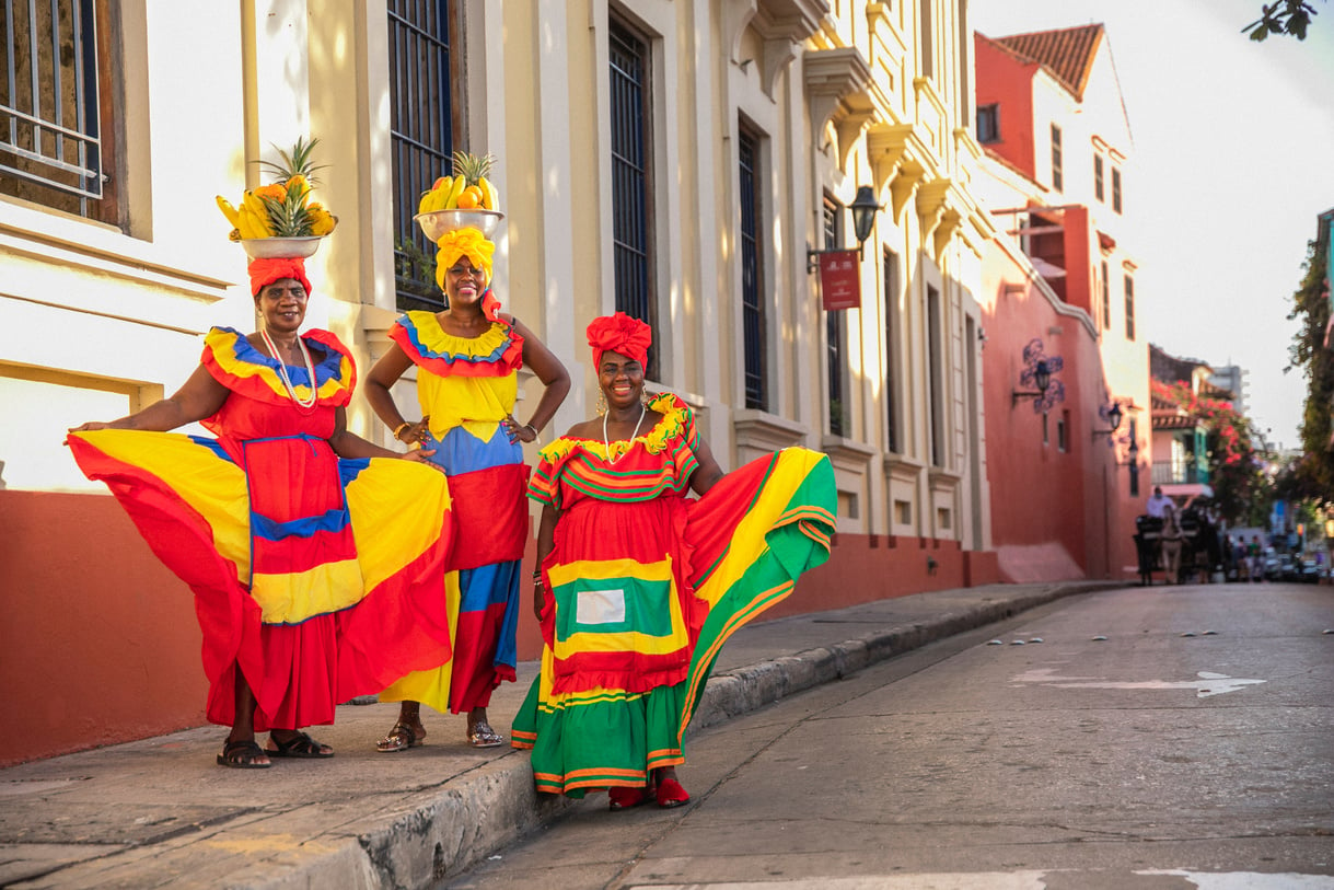 Women in Bright Dress Selling Fruits 